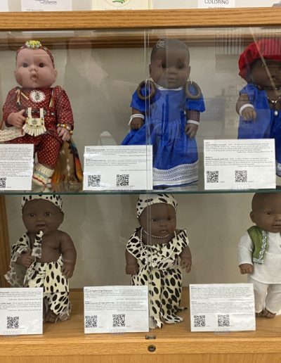 Display case showing dolls wearing different traditional clothing