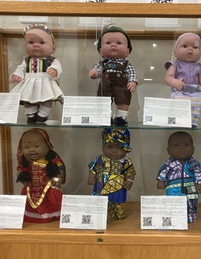 Display case showing dolls wearing different traditional clothing