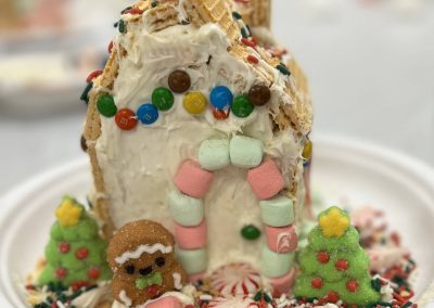 A festive gingerbread house adorned with colorful candy and candy canes, showcasing a delightful holiday treat.